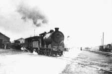 An ex-NBR Class J37 crossing West Harbour Road with a goods train – Click to enlarge