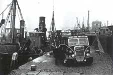 Preparing to load fish from a trawler – Click to enlarge